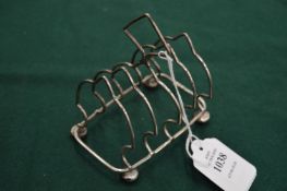 A small silver toast rack.
