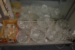 Cut glass bowls, decanter stoppers and a pair of glass candlesticks.