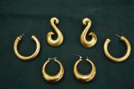 Three pairs of gilt metal earrings.