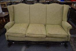 An oak framed high back three seater settee.