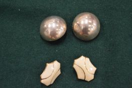 A pair of Monet earrings and a pair of silver earrings.