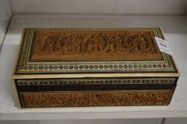 An Eastern carved sandalwood box with inlaid decoration.