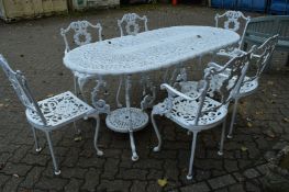 A good large white painted cast metal patio table with four armchairs and two side chairs.