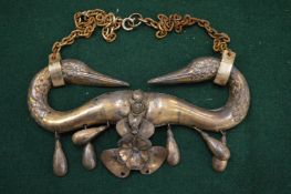 A silver swan shaped pendant.