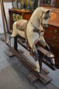 An early rocking horse on stand.
