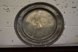 An 18th century pewter charger engraved with a figure.