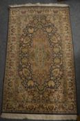 A small Persian part silk rug, 125cm x 72cm.