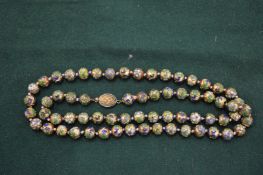 An enamel decorated bead necklace.