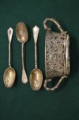 A Chinese silver twin handled pierced bowl and three silver spoons.