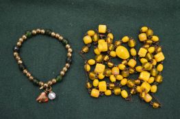 A hard stone necklace and a bracelet.