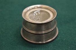 A silver inkwell.