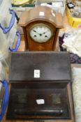 A desk stand and a mantel clock.