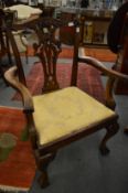 A Chippendale style mahogany chair with arms.
