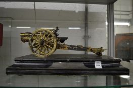 A silver model of a field gun mounted on a presentation plinth with engraved inscription, dated
