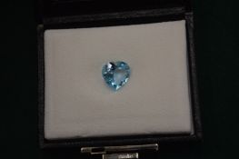 A heart shaped natural blue topaz with certificate.