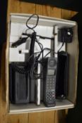An early Motorola mobile phone with accessories and original box.
