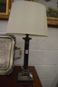 A plated corinthian column style table lamp.