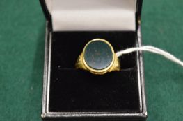 A yellow metal and bloodstone signet ring.