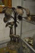 A plated centre piece, possibly Walker & Hall, modelled as a giraffe standing beneath palm trees (