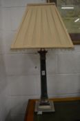 A plated and marble corinthian column style table lamp.