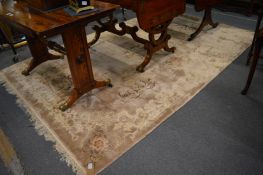 A Chinese carpet beige ground with floral decoration, 305cm x 183cm.