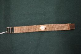 A ladies 9ct gold wristwatch with mesh bracelet.