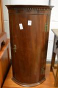 A small mahogany hanging bow fronted corner cupboard.