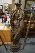 A near life size floor standing fibre glass figural lamp base.