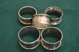 Five silver napkin rings.