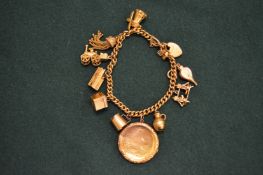 A 9ct gold bracelet containing 9ct gold and other charms.
