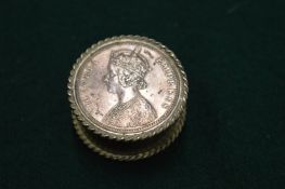 A silver coin pill box.