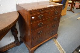 A George III mahogany caddy top chest of drawers with brushing slide, four graduated long drawers on