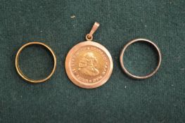 A South African gold one rand coin in a pendant mount together with a 22ct gold wedding band and