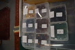 Eight boxes of colourful stones.