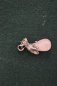 A silver and rose quartz dog pendant.