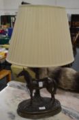 Bronze resin table lamp modelled as a horse standing beneath a tree.