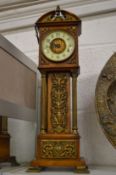 A ormolu mounted miniature long case clock.