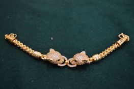 An 18ct gold plated double panther head bracelet.