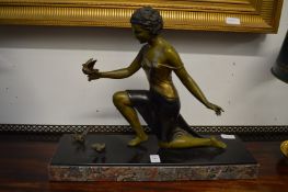 An Art Deco painted spelter figure of a kneeling lady on a marble base.