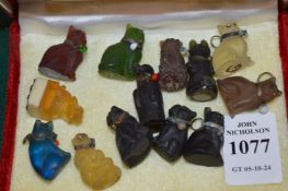A group of miniature coloured glass cats and other items.