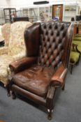 Georgian design leather upholstered wing armchair.