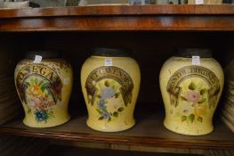 A set of three early tobacco storage jars with painted decoration.