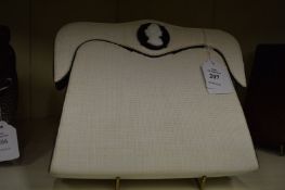 A Pellegrino cream clutch bag with cameo decoration.