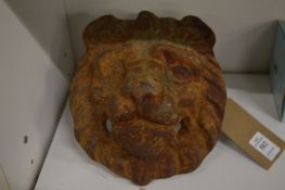 A cast iron lion mask door knocker back plate.