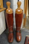 A pair of gentlemans burgundy leather riding boots with wooden trees.