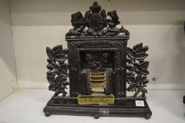An unusual miniature cast iron Victorian fireplace.