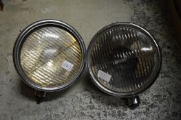 A pair of old chrome car lamps.