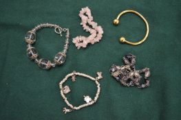 Four bracelets and a necklace.