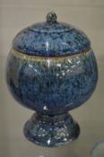 A Chinese pedestal bowl and cover with mottled blue glazed decoration.