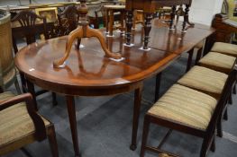 A mahogany and satinwood banded extending dining table comprising drop-leaf central section, pair of